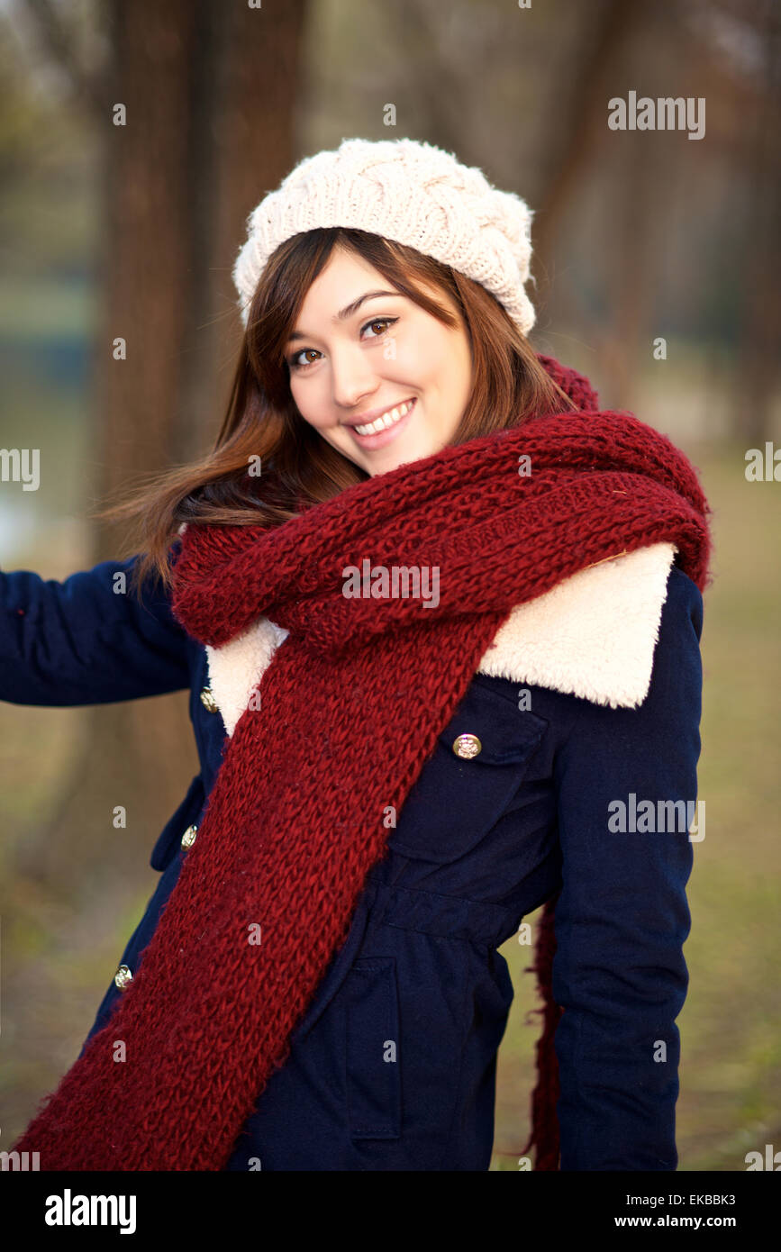 Beautiful mixed race girl in a park in Winter clothes Stock Photo