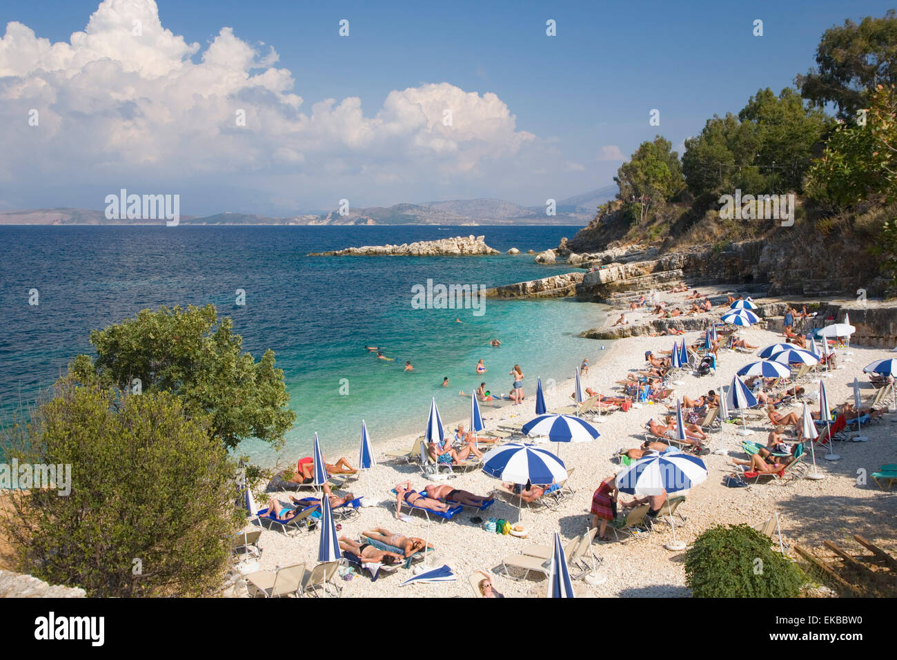 Beach crowded with holidaymakers, Kassiopi, Corfu, Ionian Islands, Greek Islands, Greece, Europe Stock Photo