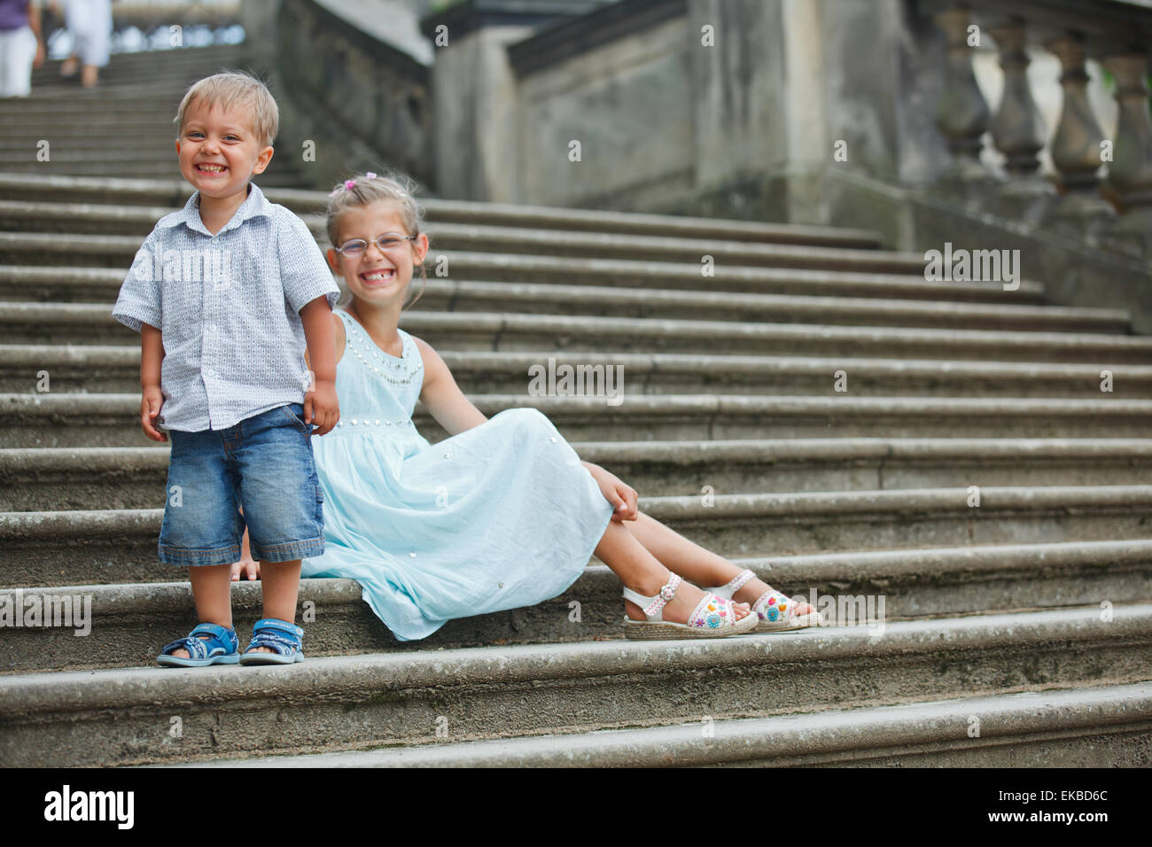 Brother and sister outdoors in city Stock Photo - Alamy