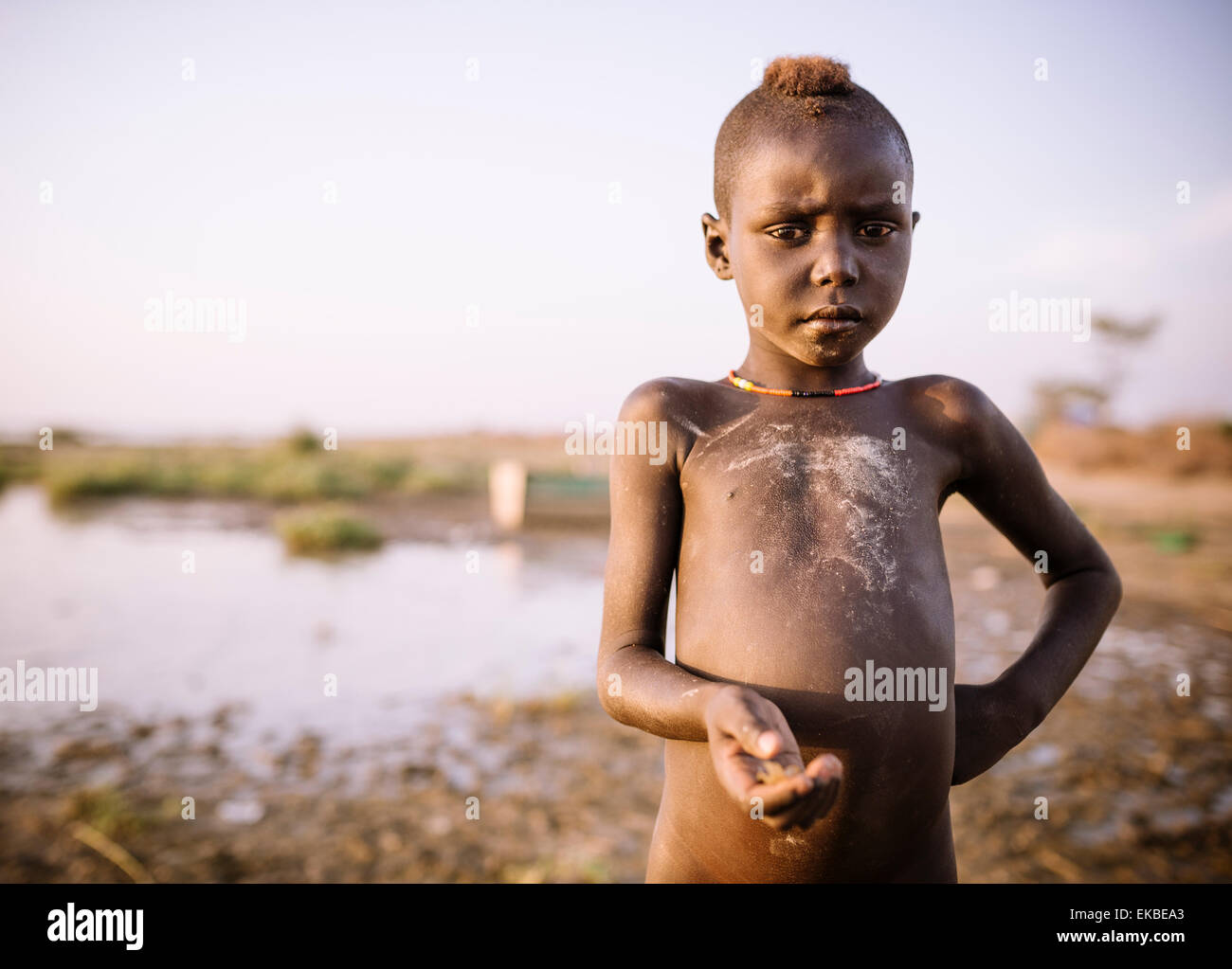 Children fishing on the shore of Turkana Lake, Dassanech Tribe, Omo Valley, Ethiopia, Africa Stock Photo