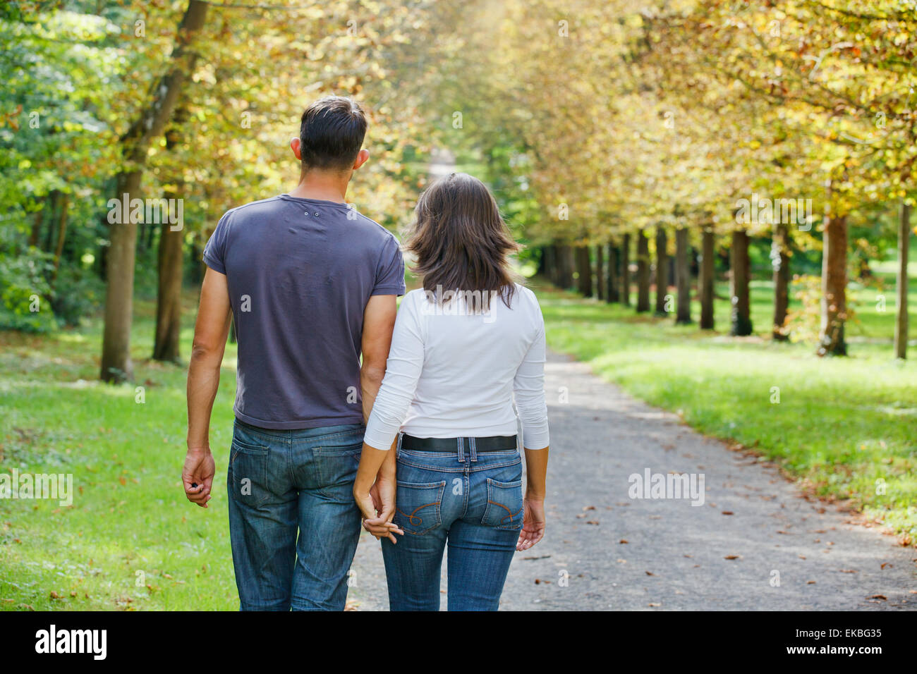 Young Couple Walking in autumn park Stock Photo - Alamy