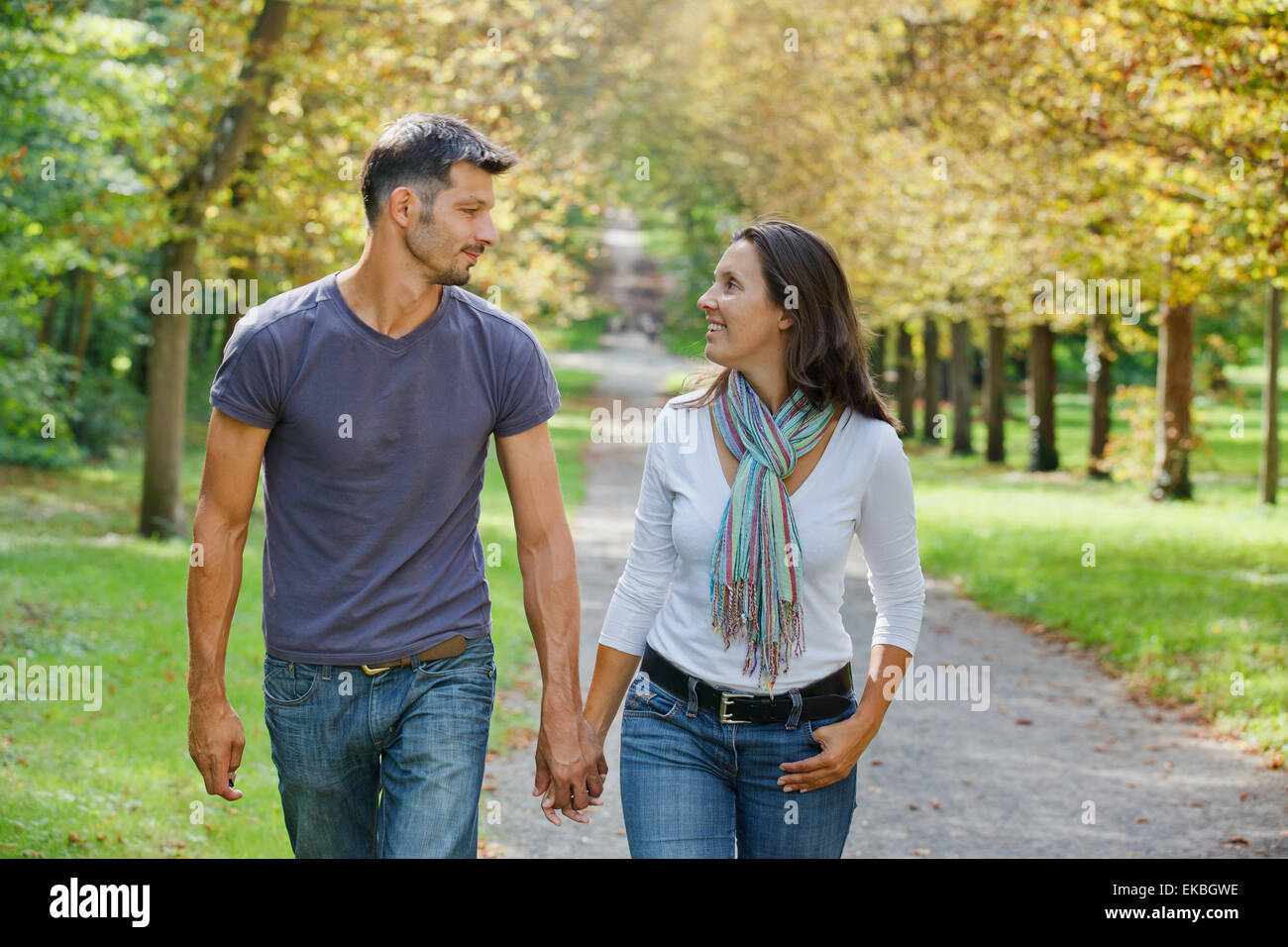 Young Couple Walking in autumn park Stock Photo - Alamy