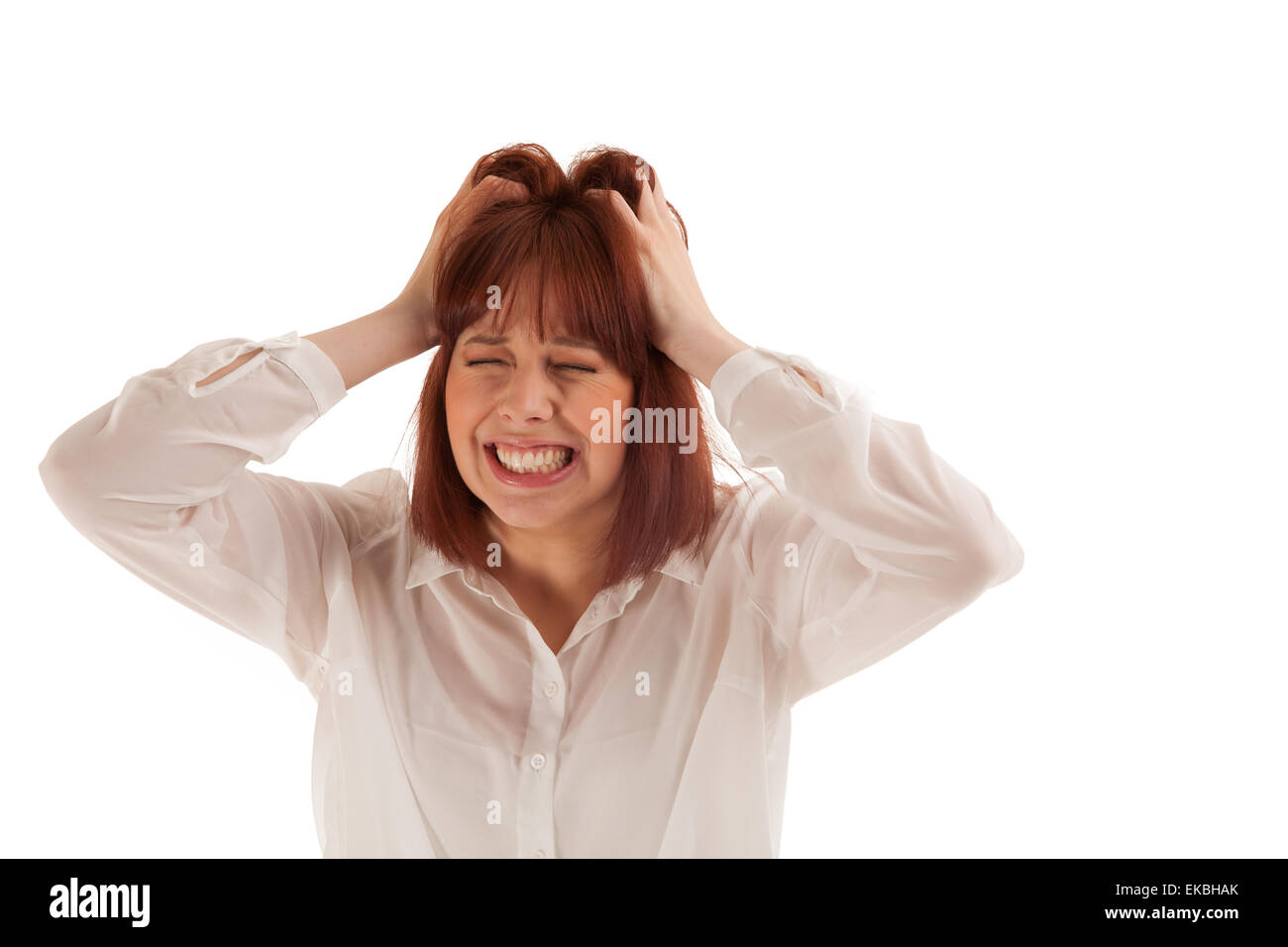 Frustrated woman tearing at her hair Stock Photo