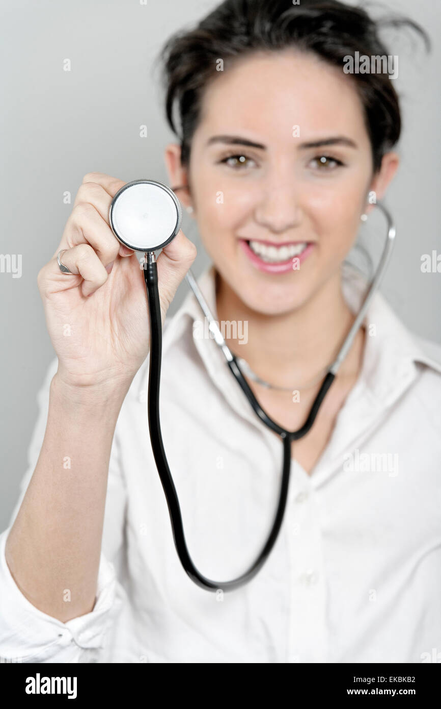 Female doctor using a stethoscope Stock Photo - Alamy