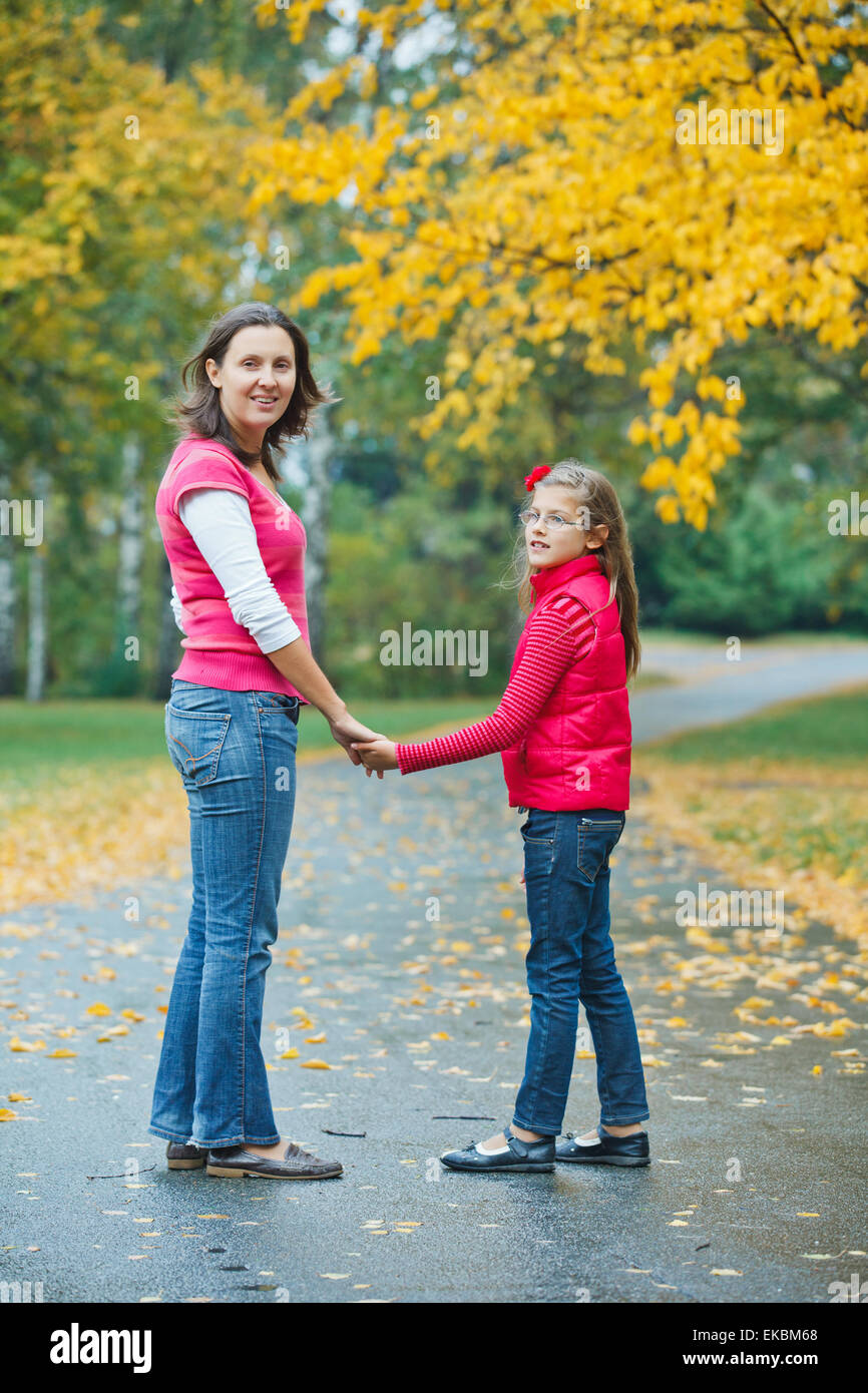 Cute girl with her mother walking in park Stock Photo - Alamy