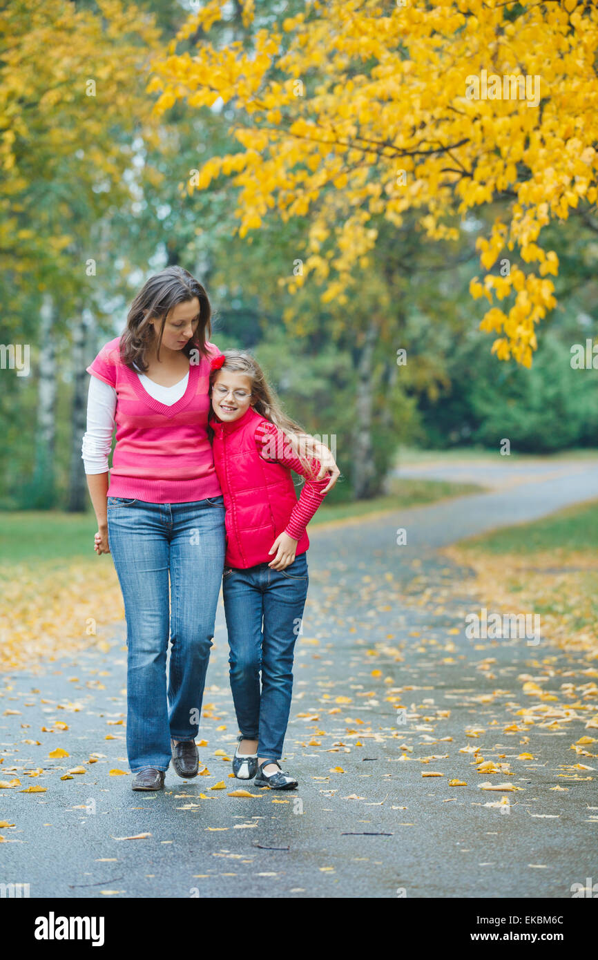 Cute girl with her mother walking in park Stock Photo - Alamy