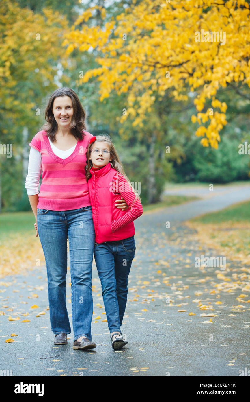 Cute girl with her mother walking in park Stock Photo - Alamy