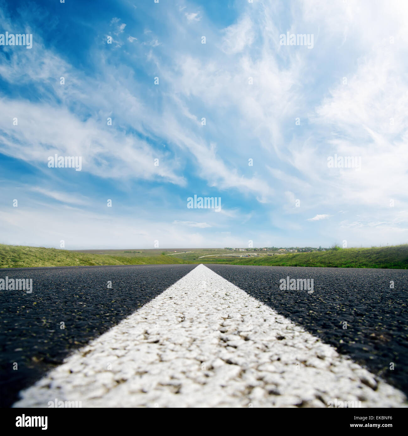 white line on asphalt road close up and cloudy sky Stock Photo - Alamy