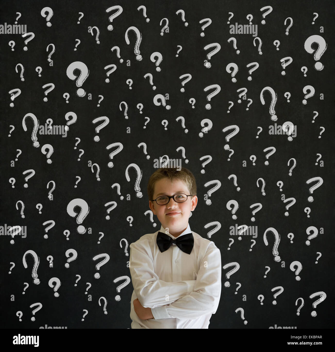 Thinking boy dressed as business man with chalk question marks Stock ...