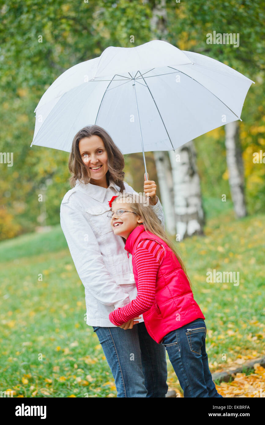 Cute girl with her mother walking in park Stock Photo - Alamy
