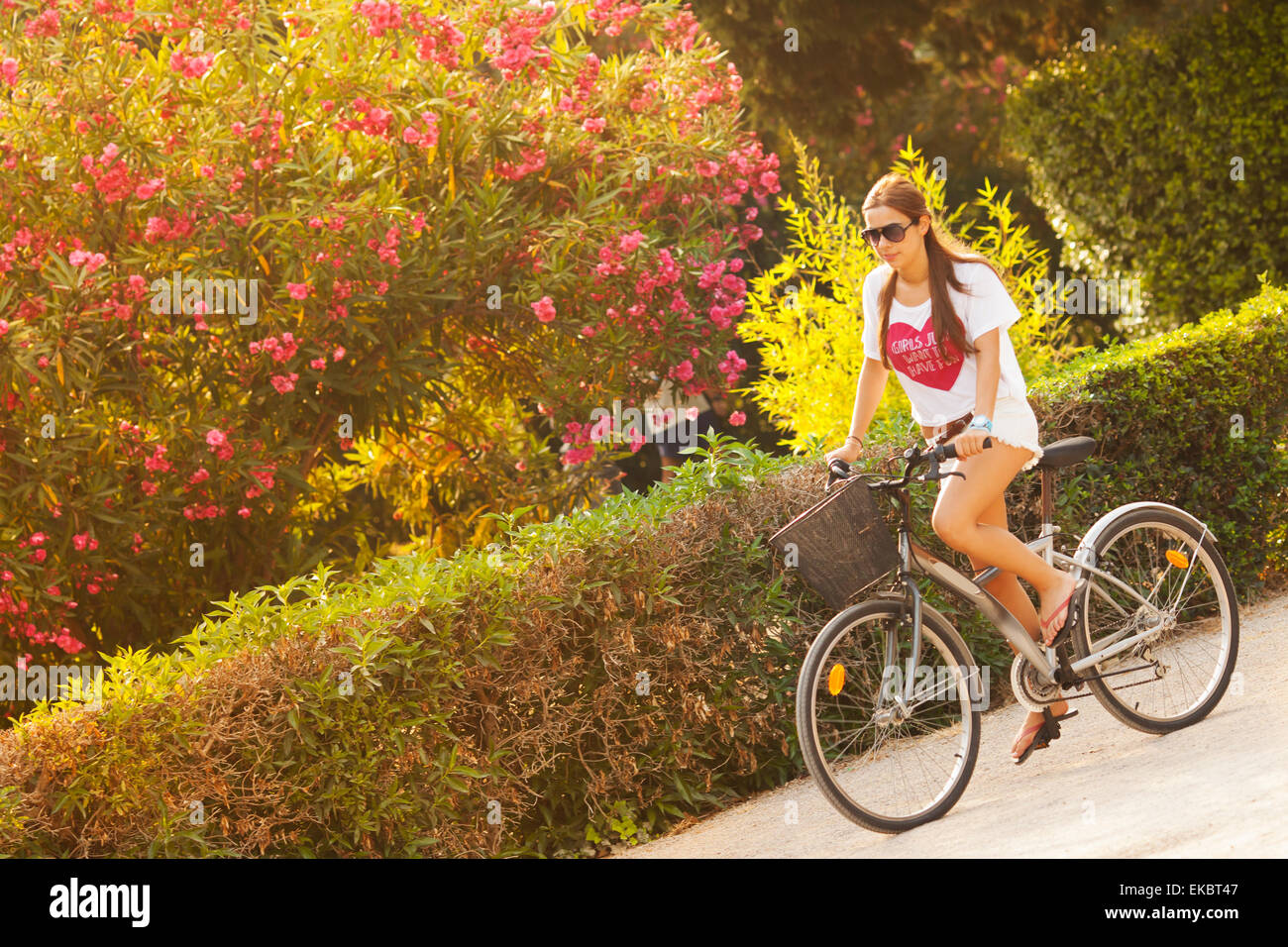 Young beautiful woman riding bicicle on summer Stock Photo