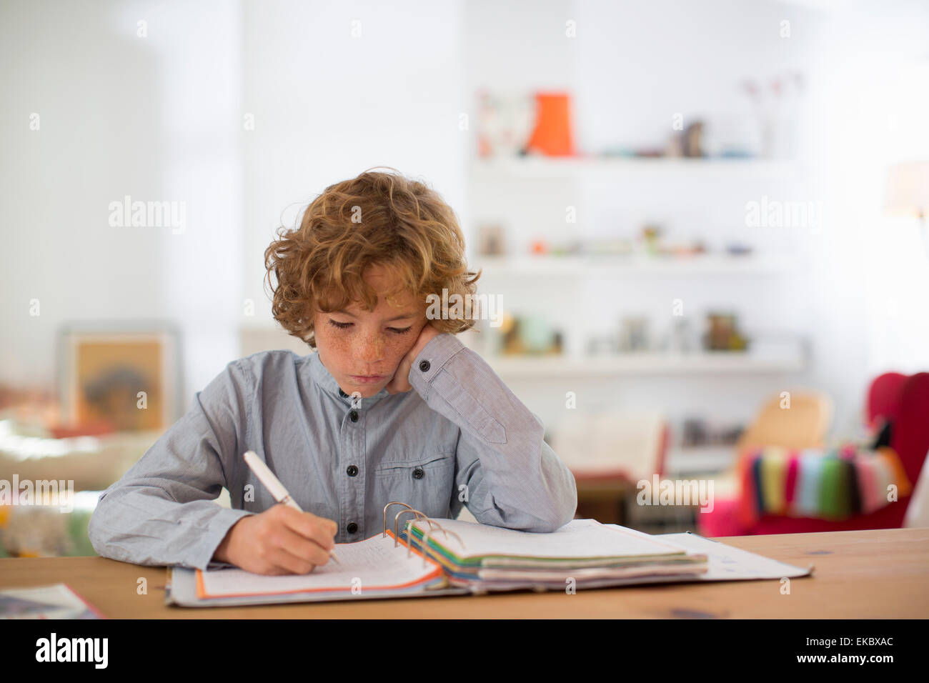 Teenage boy studying and writing notes Stock Photo