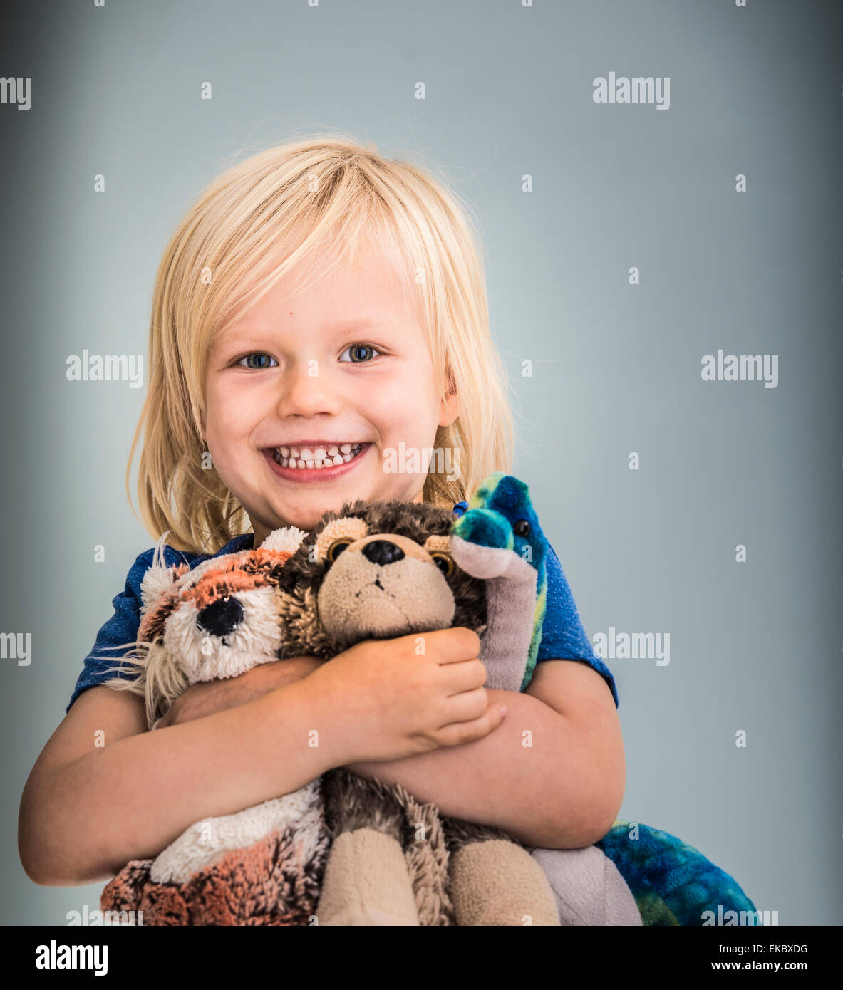 Portrait of young boy holding cuddly toys Stock Photo