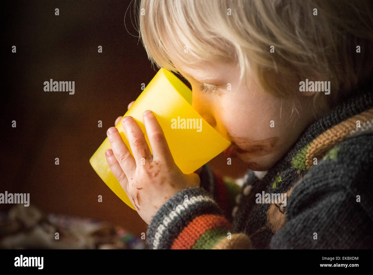 Portrait of young boy drinking from beaker Stock Photo