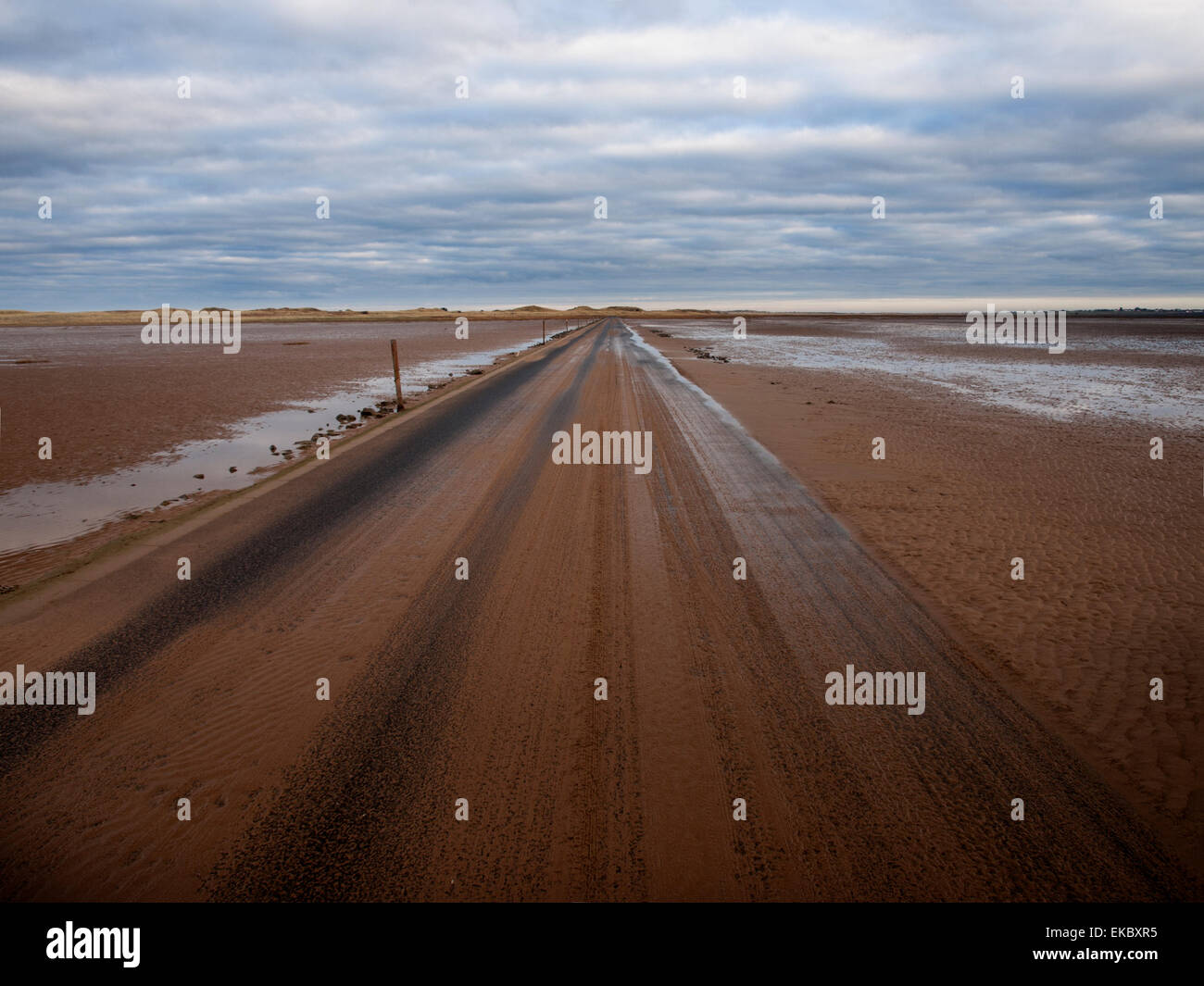 Causeway at low tide to Lindisfarne island. Stock Photo