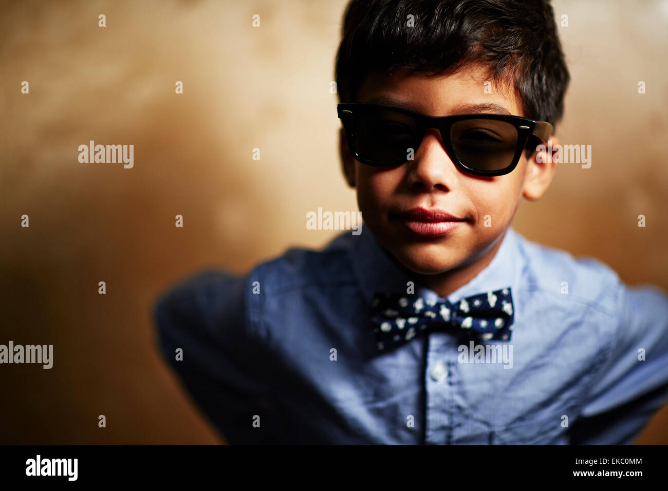 Boy wearing sunglasses and bow tie Stock Photo