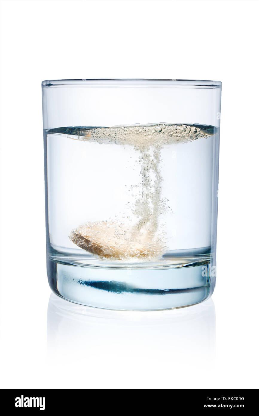 glass with efervescent tablet in water with bubbles Stock Photo