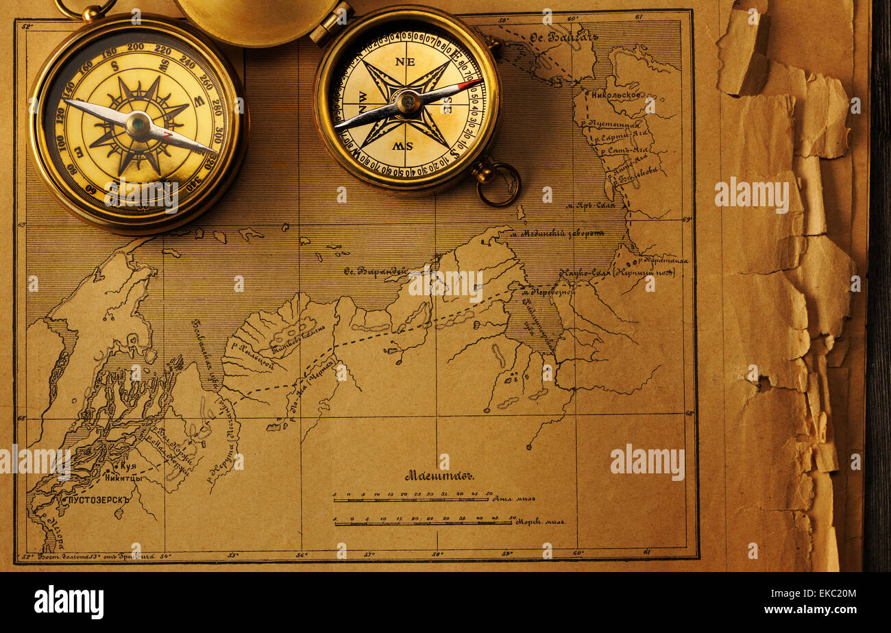 Antique compass over old map Stock Photo