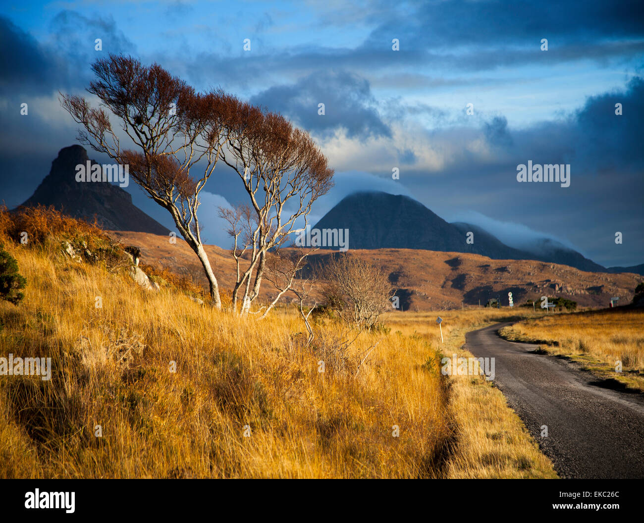 Storm clouds over rural road and mountains, Assynt, North West Highlands, Scotland, UK Stock Photo