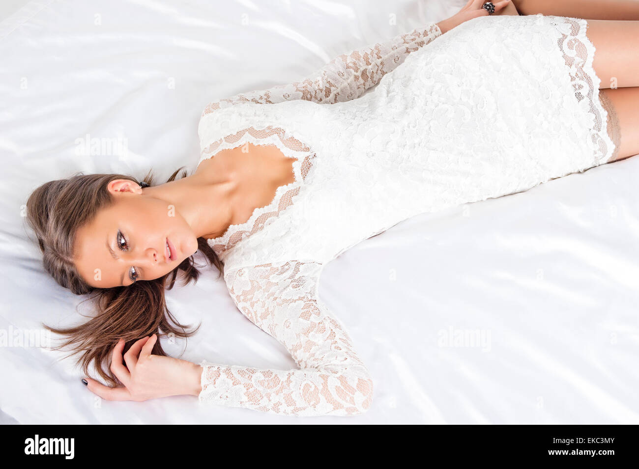 Young girl lying on the bed on her back Stock Photo - Alamy