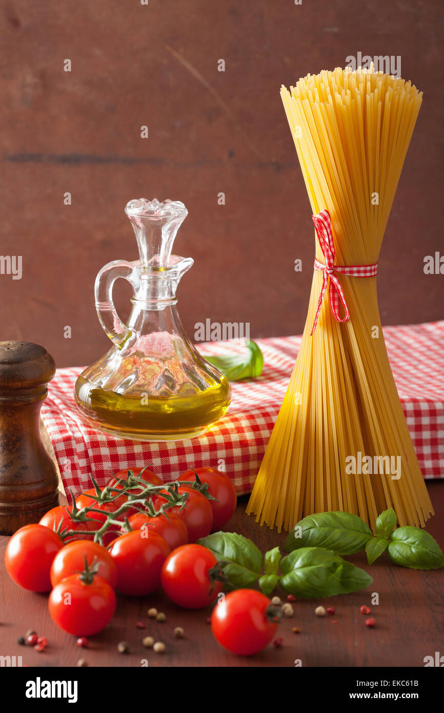 raw pasta olive oil tomatoes. italian cuisine in rustic kitchen Stock