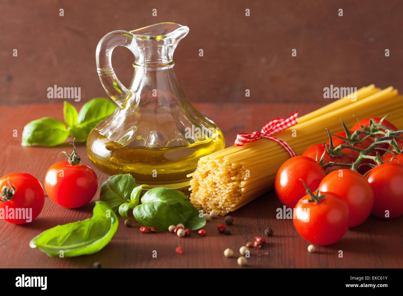 raw pasta olive oil tomatoes. italian cuisine in rustic kitchen Stock