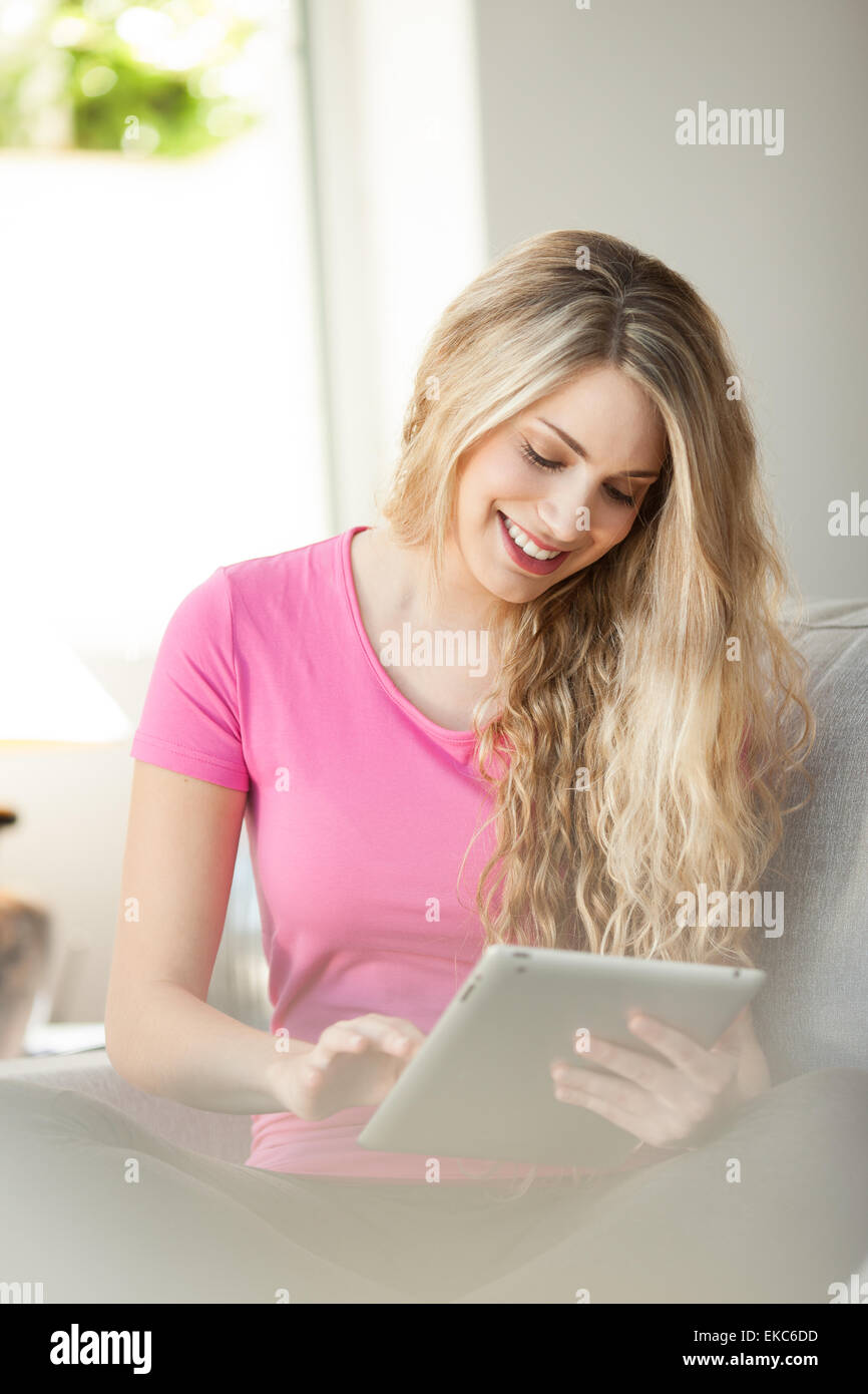 young beautiful woman using tablet at home Stock Photo - Alamy