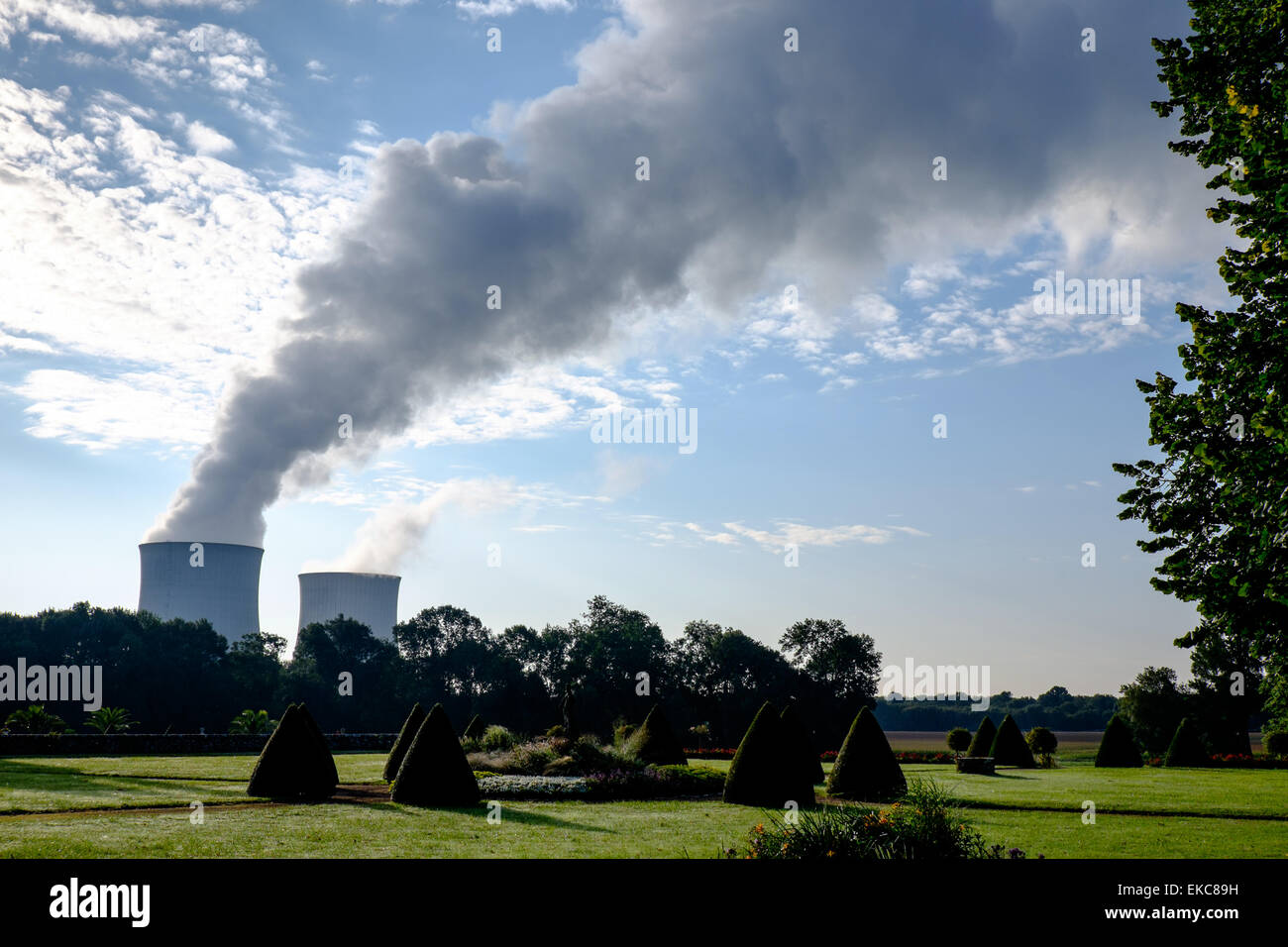 View from gardens of Chateau d'Avaray of cooling towers of Saint-Laurent Nuclear Power Station on the Loire river at Saint-Laure Stock Photo