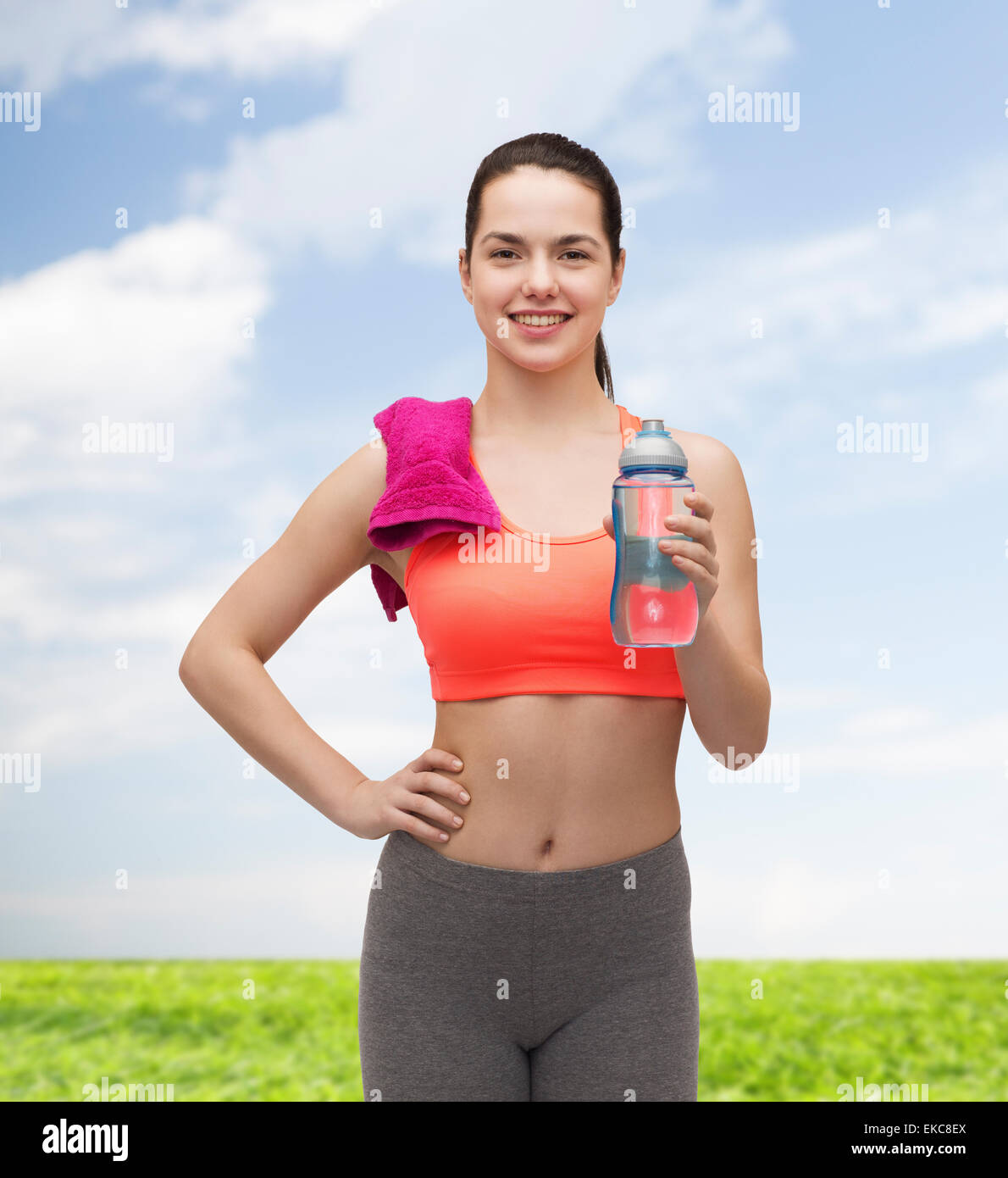 sporty woman with towel and water bottle Stock Photo - Alamy