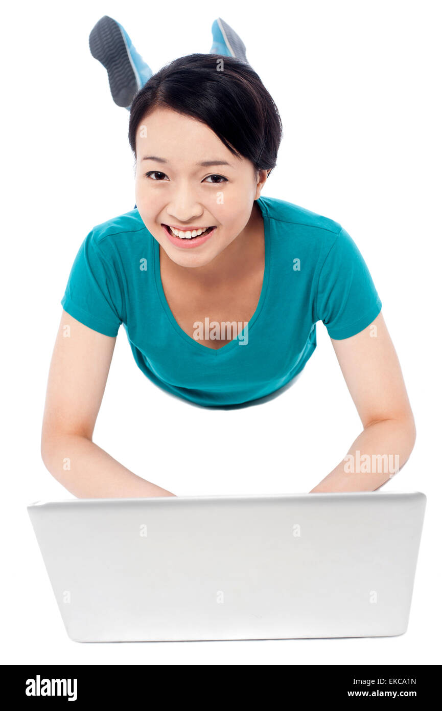 Girl lying on the studio floor and using laptop Stock Photo - Alamy