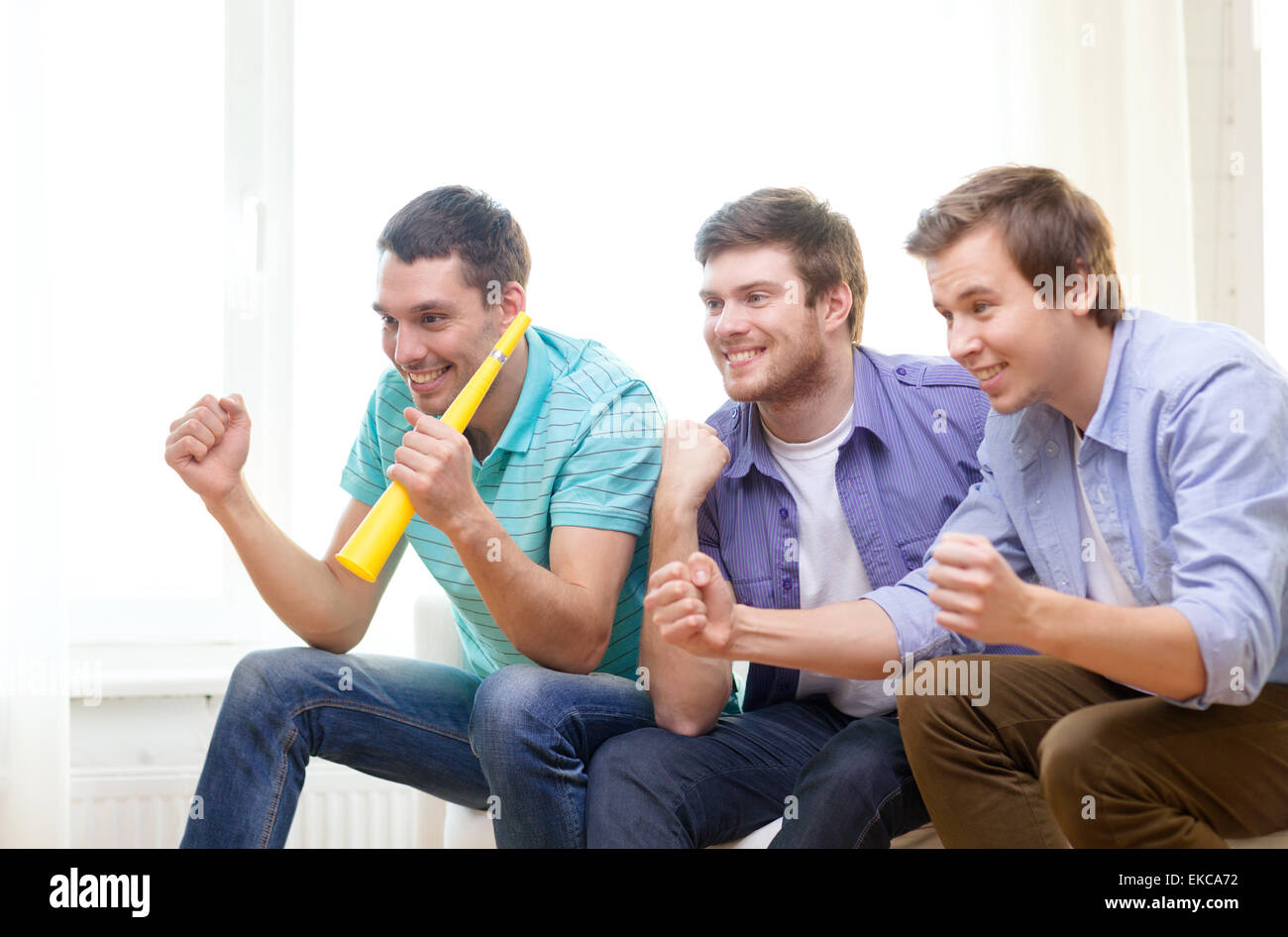 Happy excited friends watching football hi-res stock photography and ...