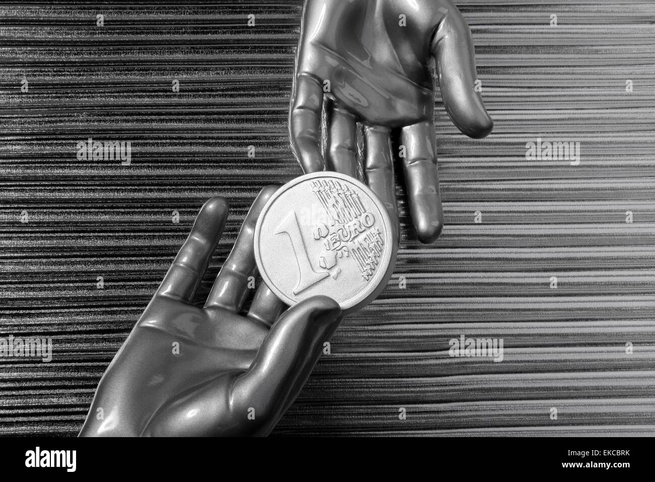 silver euro coins in futuristic robot hands Stock Photo - Alamy