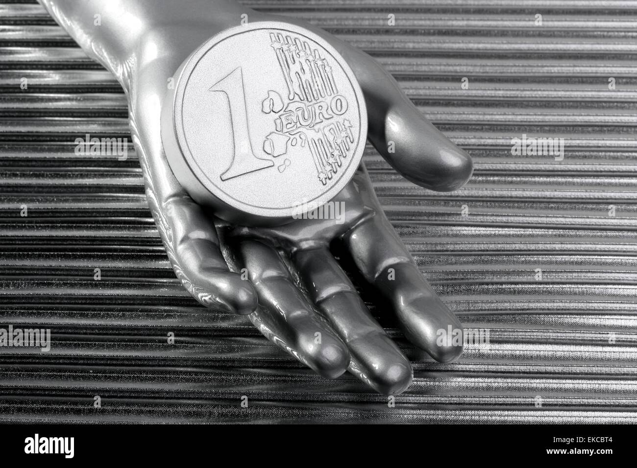 euro silver coin of futuristic metallic silver hand Stock Photo - Alamy