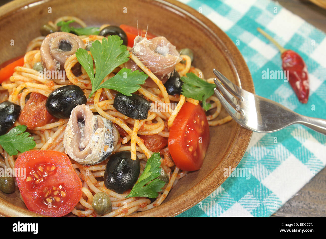 Spaghetti alla puttanesca with capers and anchovies Stock Photo - Alamy