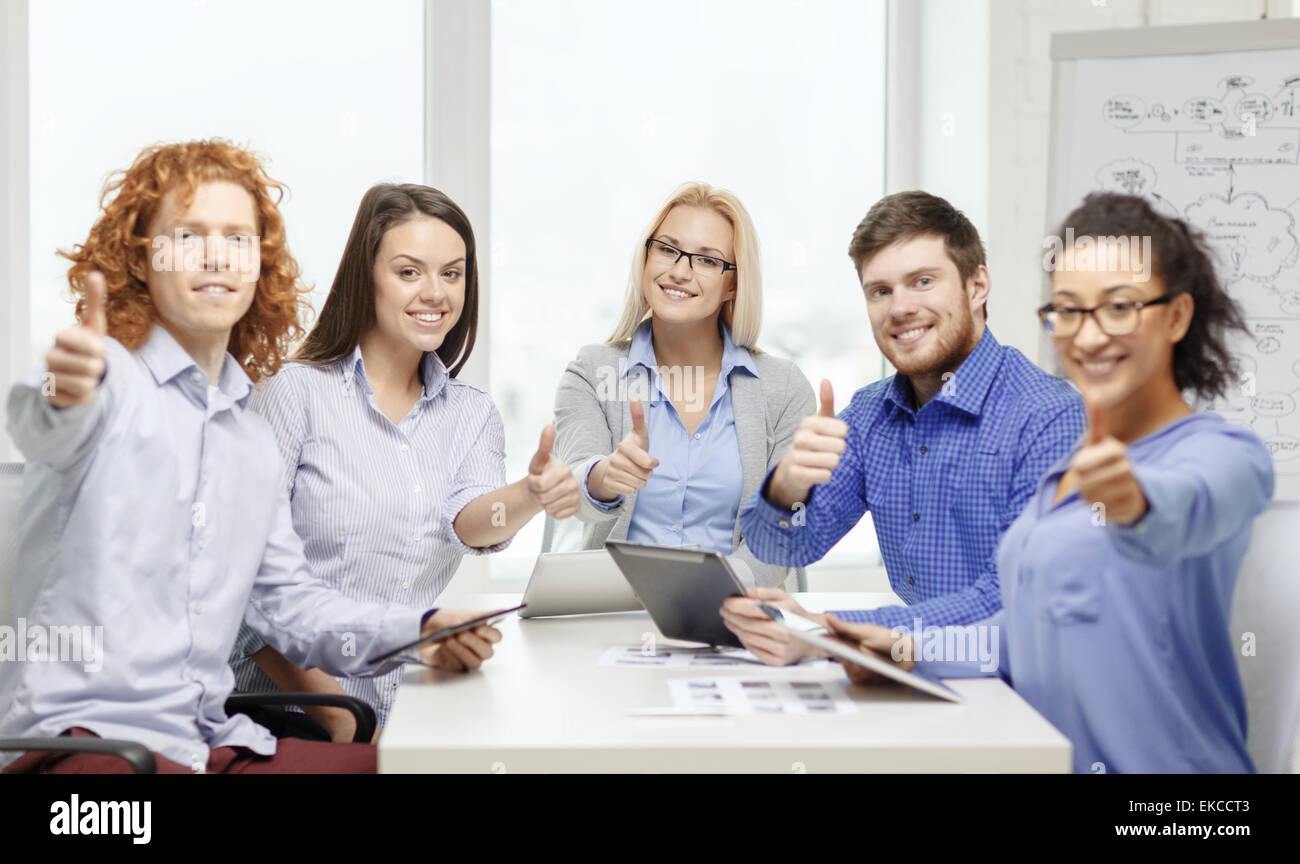 smiling team with table pc and papers working Stock Photo - Alamy