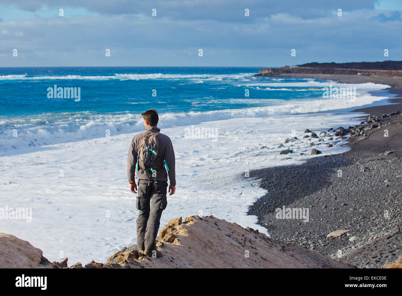 Young man hiking up mountain hi-res stock photography and images - Alamy