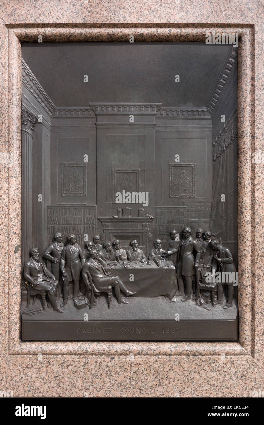 Bronze relief of Cabinet Council in 1867 on the granite pedestal of the statue of Lord Derby, Parliament Square, London UK Stock Photo