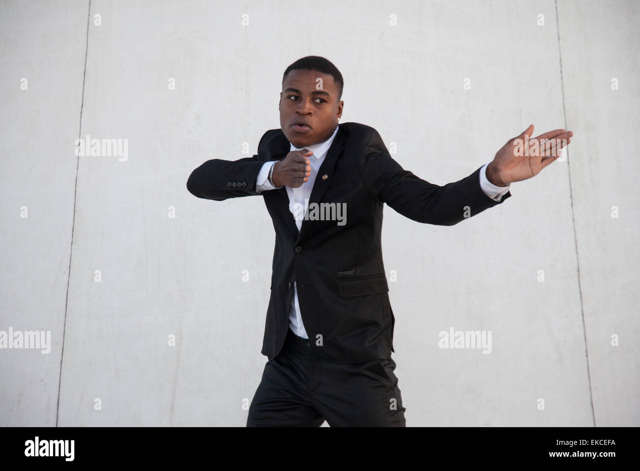 Portrait of a man in a suit dancing Stock Photo