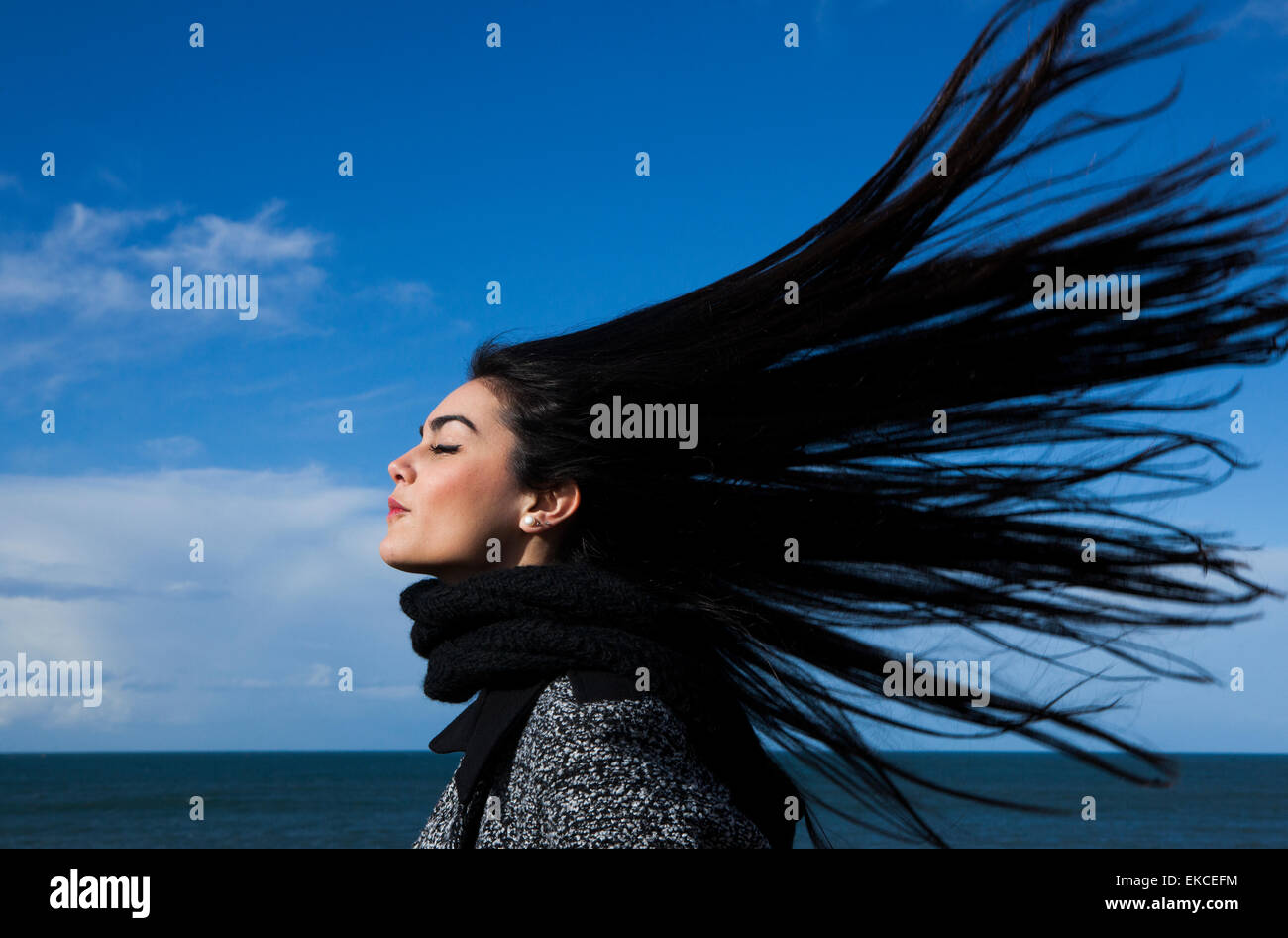Young woman with hair blowing in the wind Stock Photo