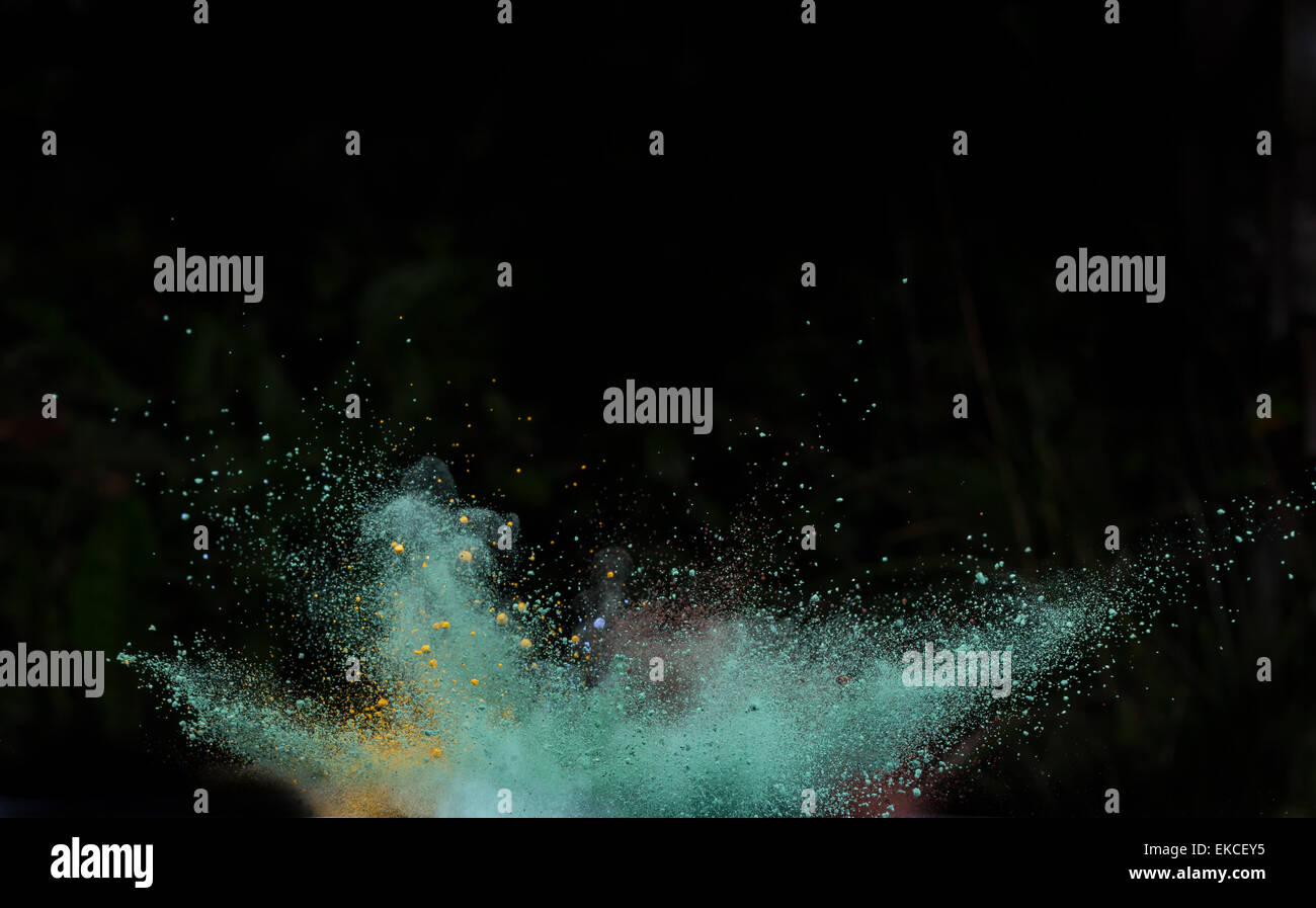 Launched colorful powder, isolated on black background Stock Photo - Alamy