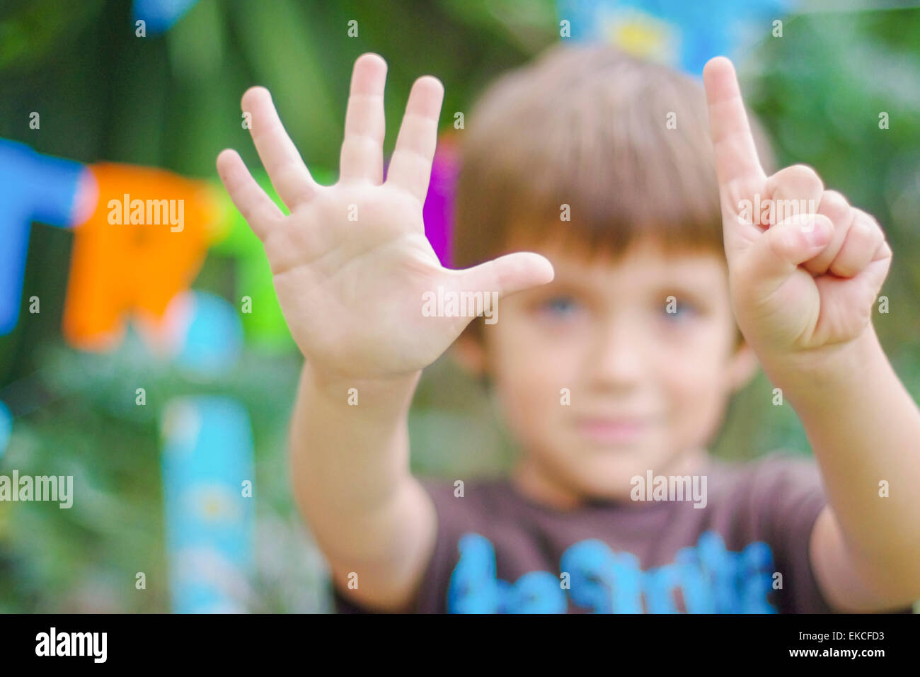 Birthday boy showing the number six with his hands Stock Photo