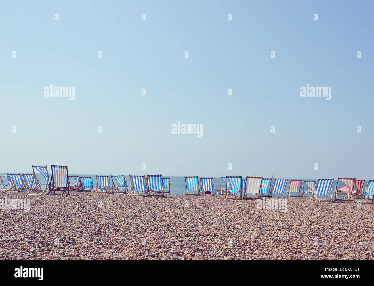 Deckchairs in a row on Brighton Beach, UK Stock Photo