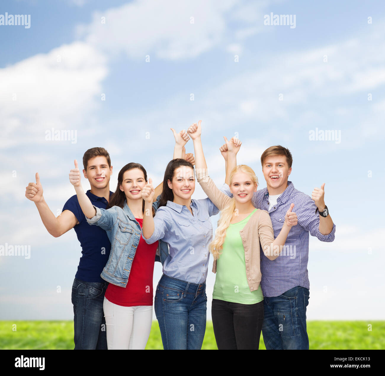 group of smiling students showing thumbs up Stock Photo - Alamy