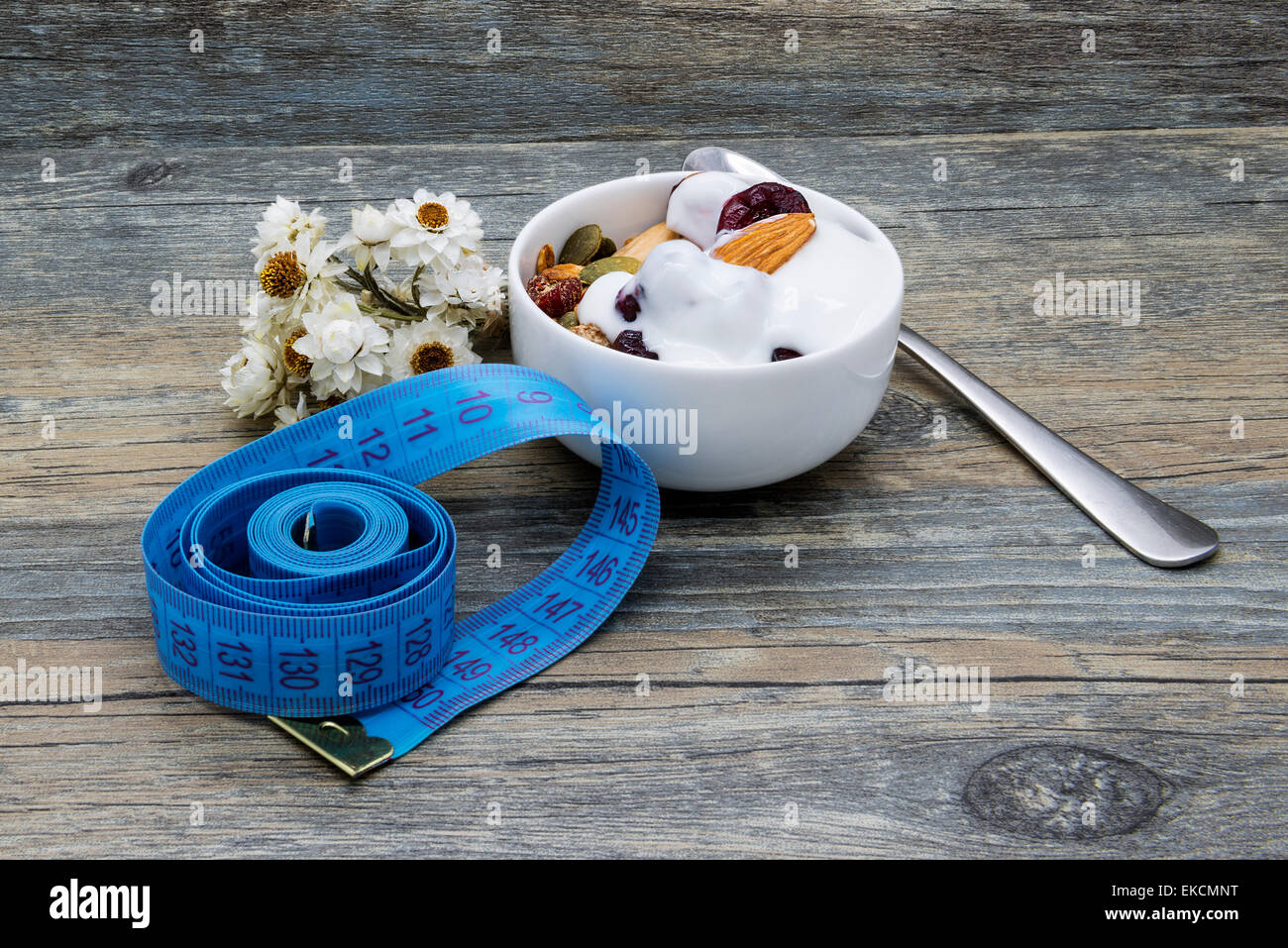 Diet breakfast with granola and yogurt on rustic wooden background. Stock Photo