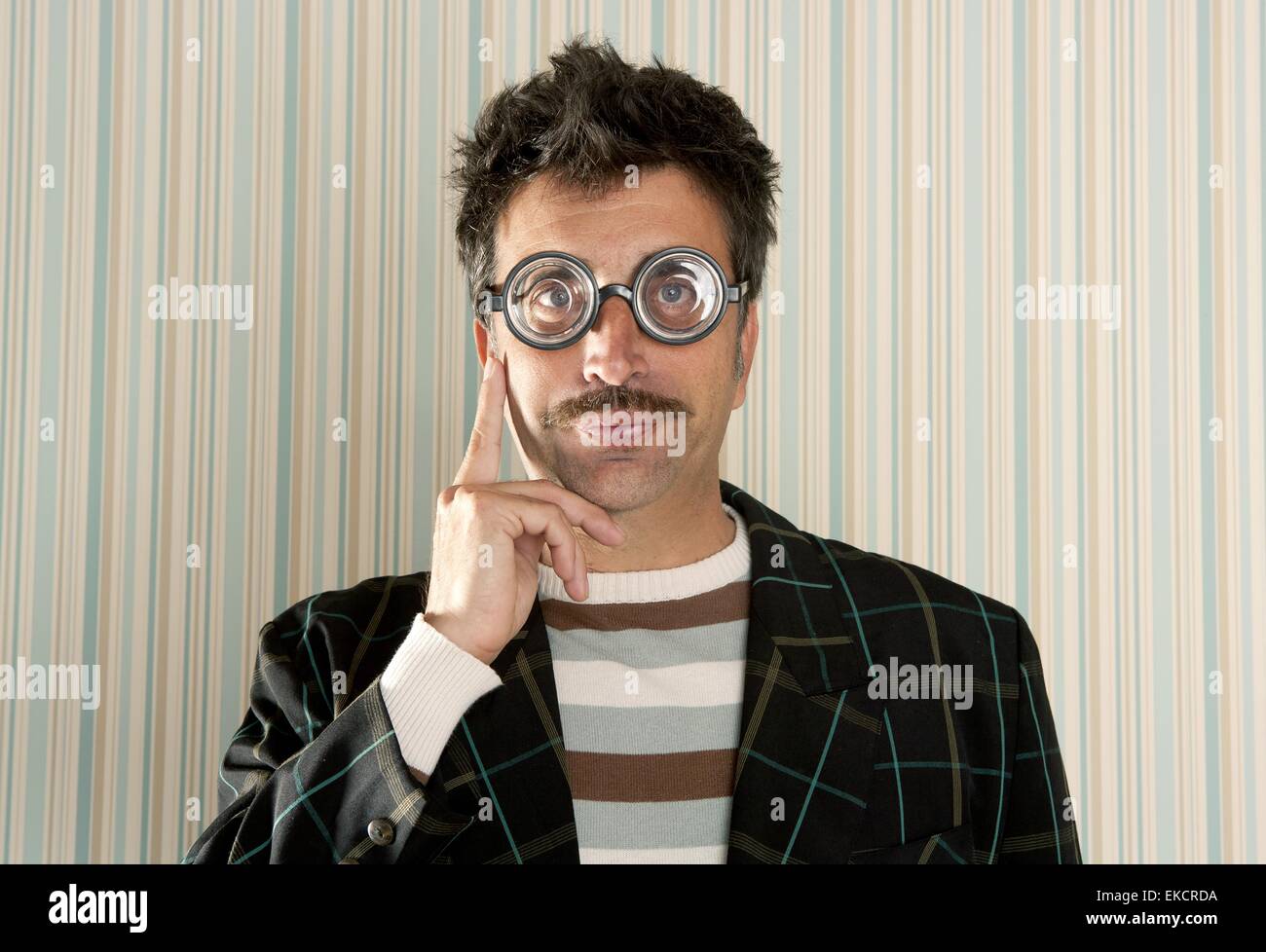crazy nerd man myopic thinking funny gesture Stock Photo