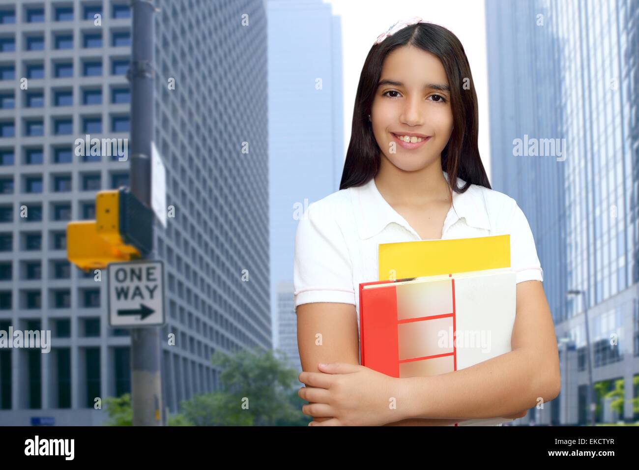 Brunette student young girl teen latin holding books Stock Photo - Alamy