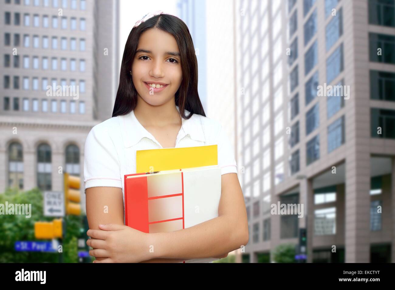 Brunette student young girl teen latin holding books Stock Photo - Alamy