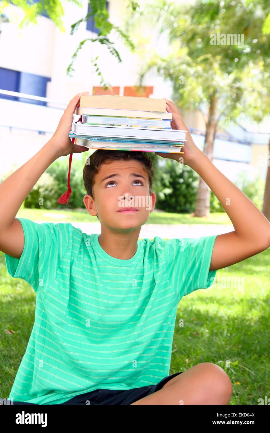 boy teenager student holding head stacked books Stock Photo - Alamy