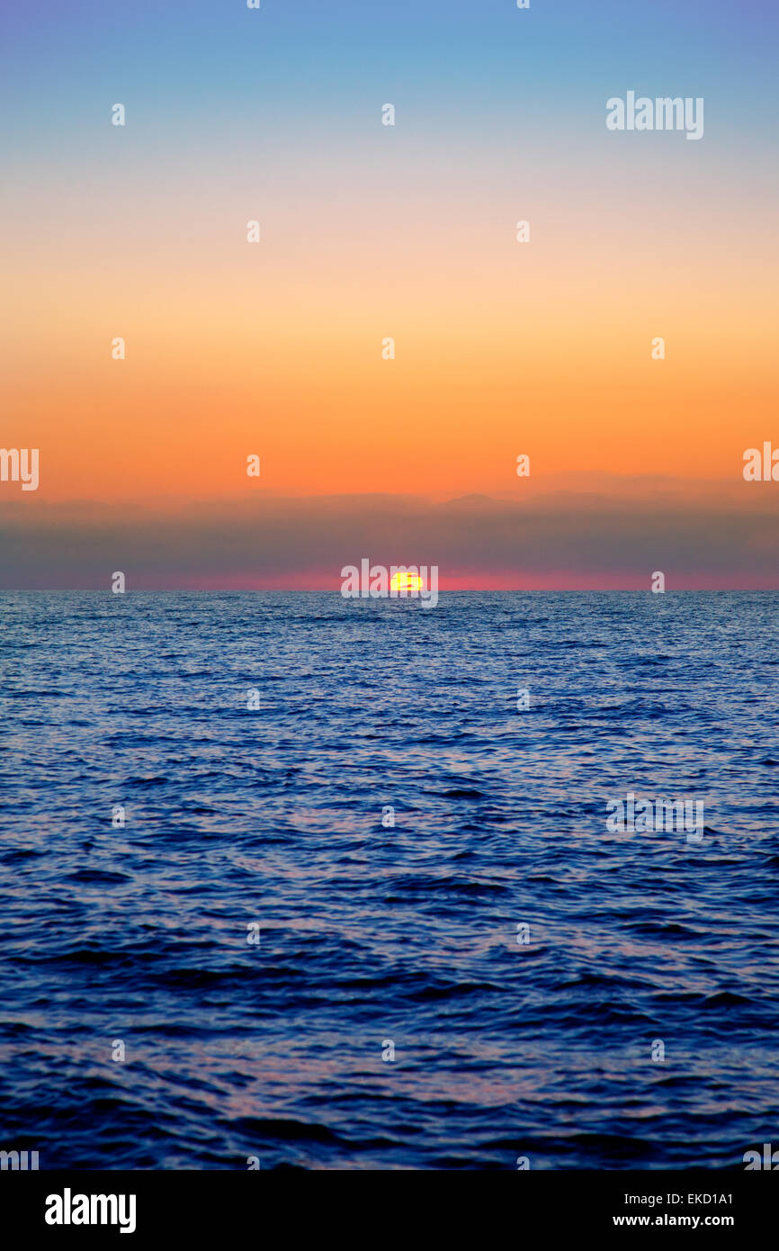 blue sea sunrise with sun in horizon Stock Photo - Alamy