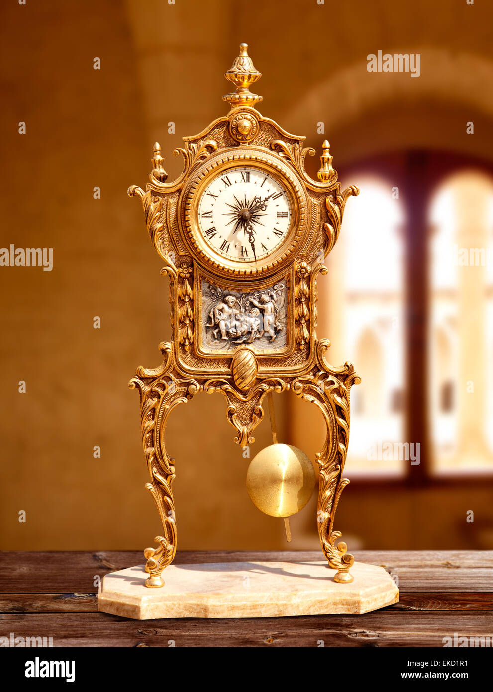 ancient vintage golden brass pendulum clock Stock Photo